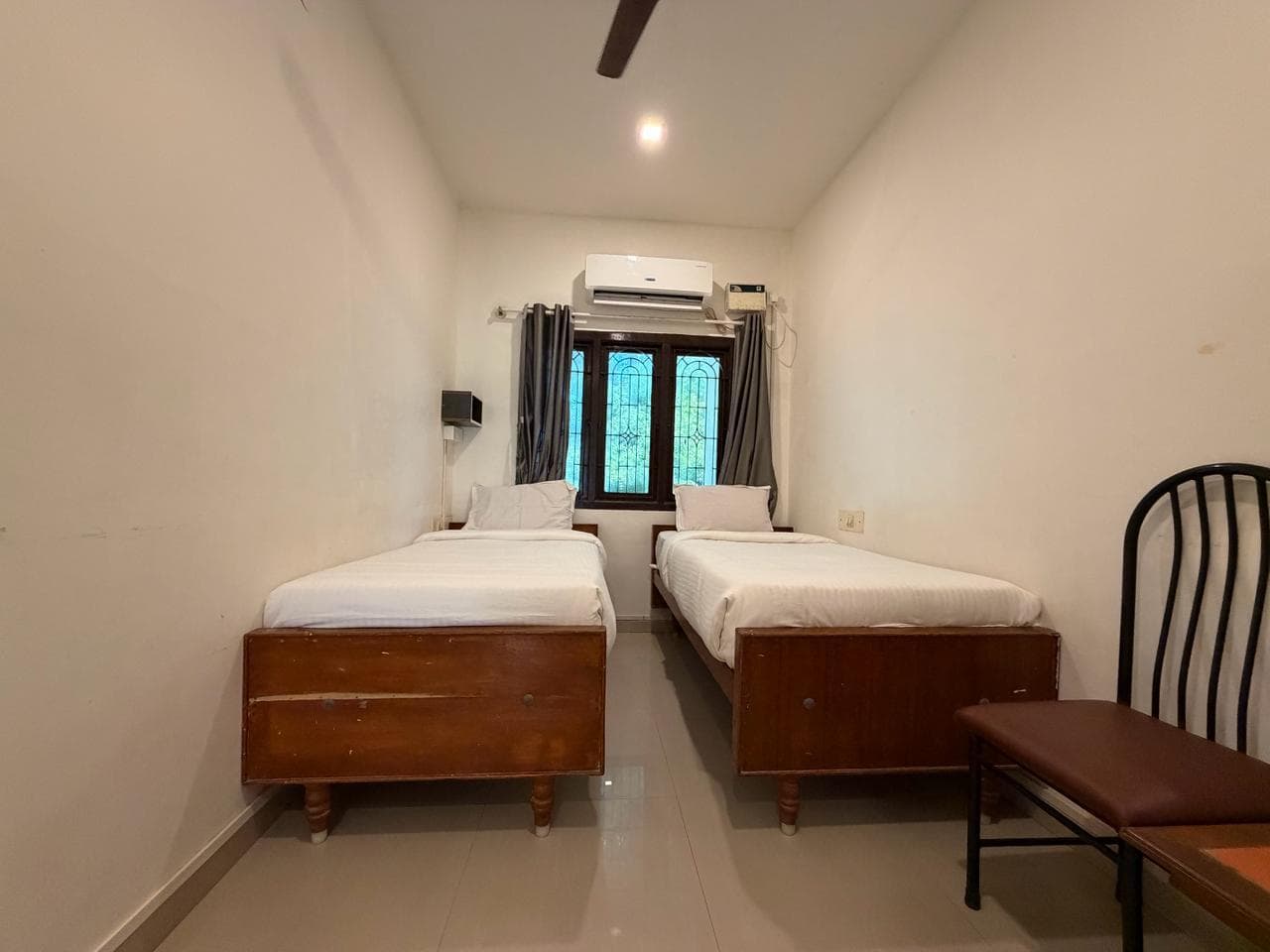 Compact Twin room, wide front view of separated beds