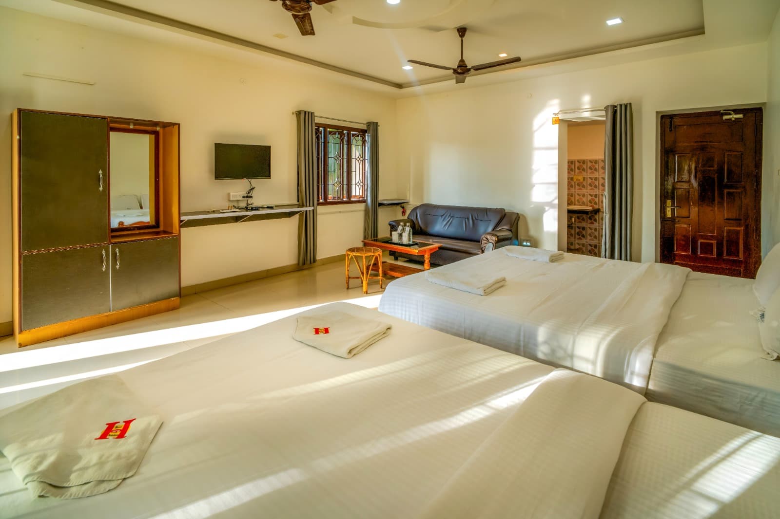 Family Room with Private Balcony, beds facing TV and sofa