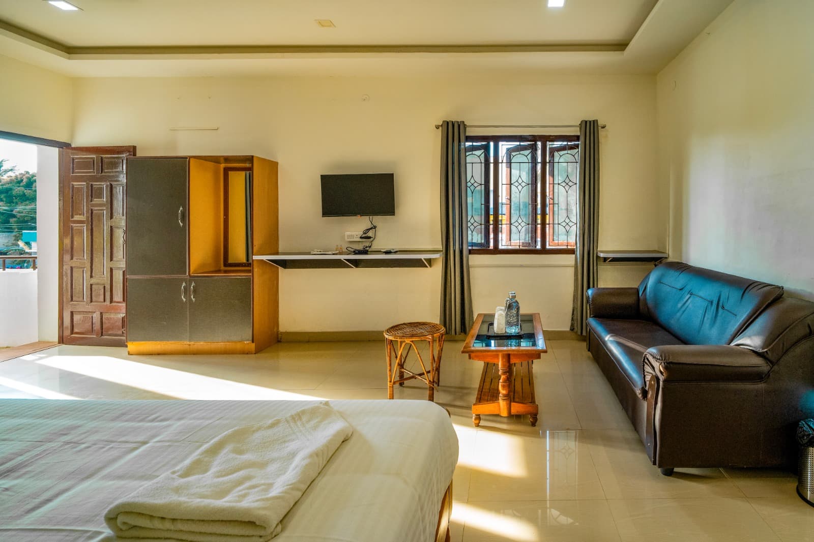 Family Room with Private Balcony, TV, seating and door